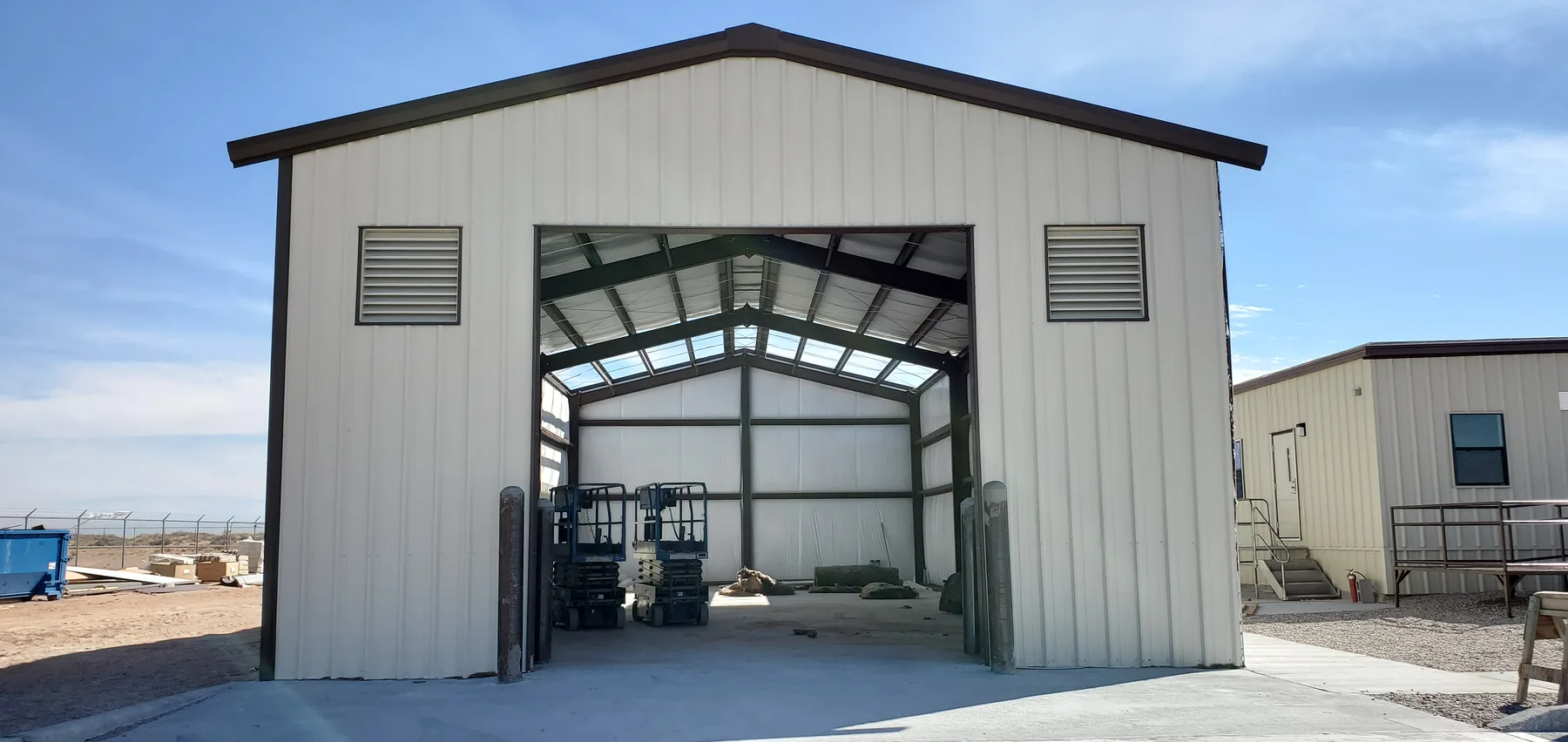 Completed Fort Bliss metal apparatus building with its bay door open